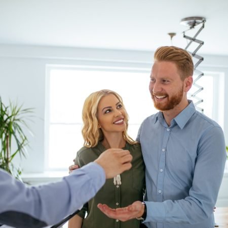 Photo of a young couple buying a new  house.